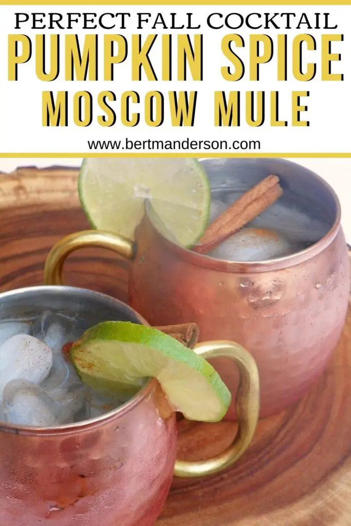 Pumpkin Spice Moscow Mule - the perfect fall cocktail shown in copper mugs with cinnamon stick and lime wedge