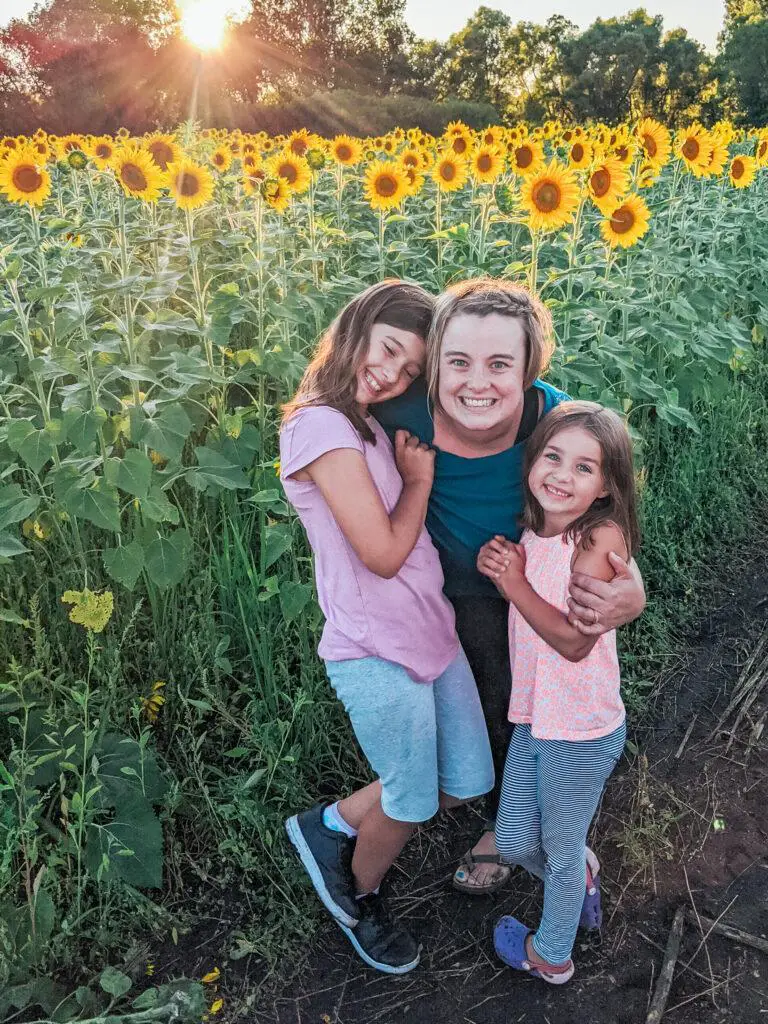 Letting your child struggle - girls in field of sunflowers