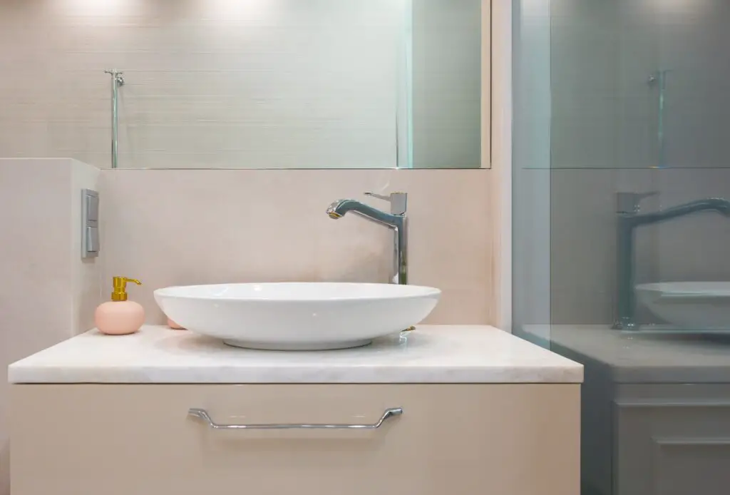 Bathroom with sink and soap dispenser.